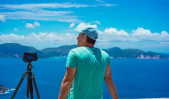 Summer holiday visiting Greece. Male photographer enjoying to capture time lapse cloudscape