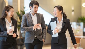 Businessman and businesswoman talking when walking