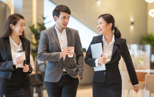 Businessman and businesswoman talking when walking