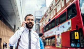 Hipster businessman on the street in London, making a phone call.