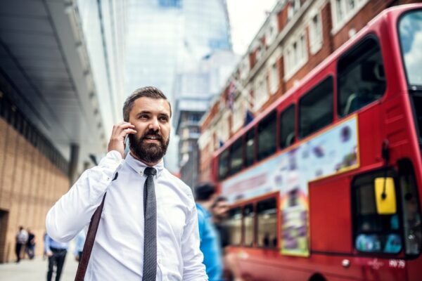 Hipster businessman on the street in London, making a phone call.