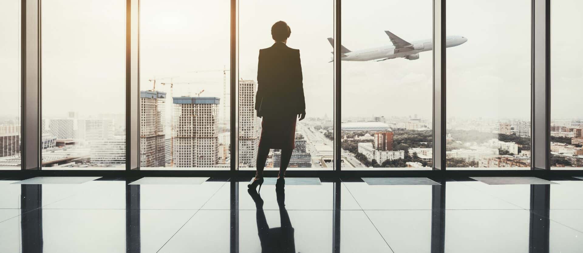 Businesswoman indoors and airplane