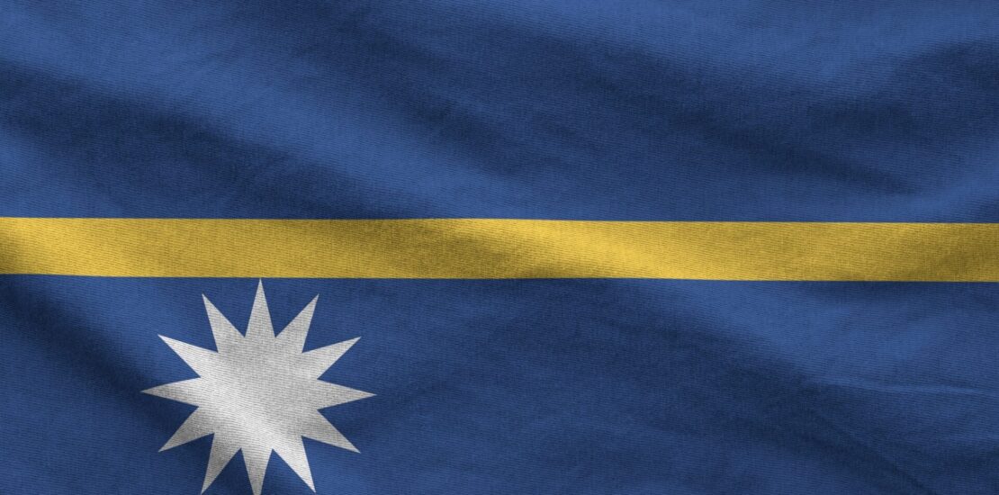 Nauru flag depicted on folded wavy fabric of old cloth