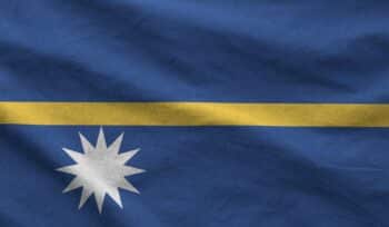 Nauru flag depicted on folded wavy fabric of old cloth