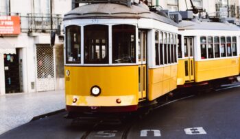 Lisbon street with yellow tramcar, Portugal.