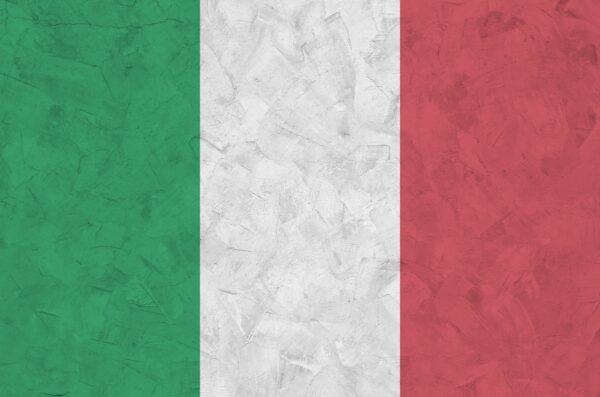Italy flag depicted in bright paint colors on old relief plastering wall close up