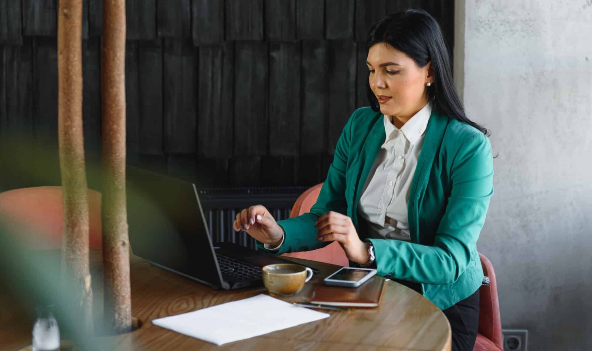 Young pretty business woman with notebook in the office