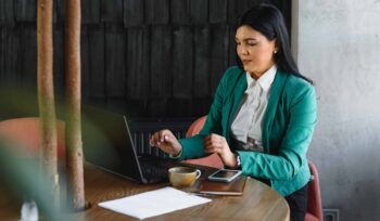 Young pretty business woman with notebook in the office