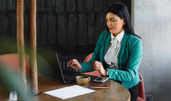 Young pretty business woman with notebook in the office