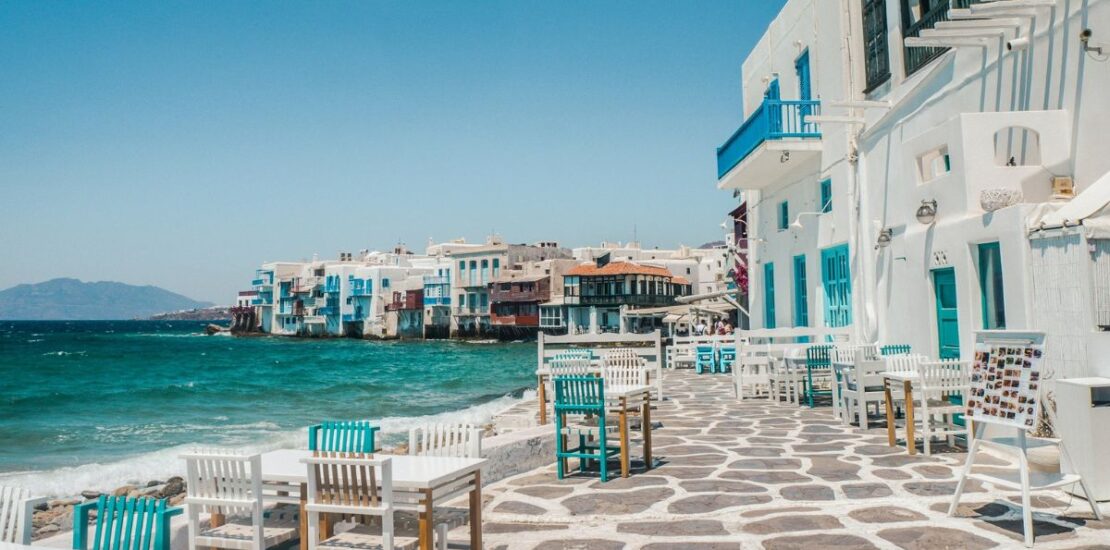 white and brown concrete buildings near sea in Greece.